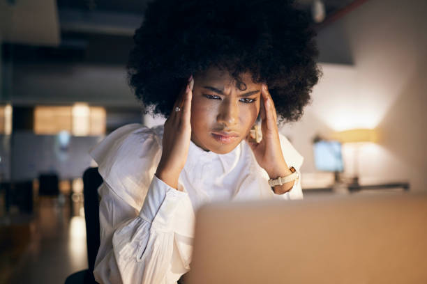 istock Headache, stress and black woman with a work problem, laptop glitch and reading an email in the dark. Sad, tired and frustrated African corporate employee with anxiety working overtime at night 1440479427