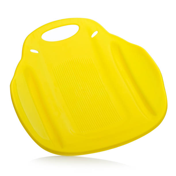 istock Children's plastic yellow sled isolated on a white background. Sleds for skiing downhill in winter. Children's toys. Slide board 1440479573