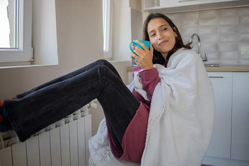 Young woman feel cold in home with no heating