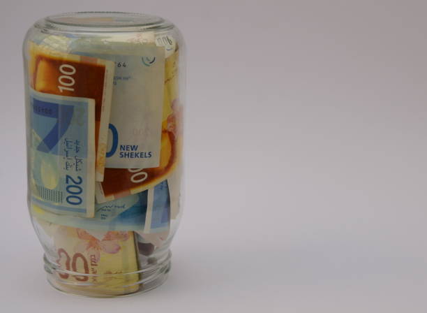 istock New Israeli shekels in glass jar. Copy space 1440481354