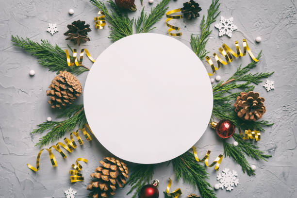 istock Flat lay Christmas composition. Round Paper blank, pine tree branches, christmas decorations on Colored background. Top view, copy space for text 1440481400