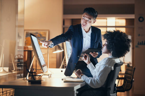 istock Night, office and teamwork of business people on computer working late, project deadline or writing report. Company, corporate or collaboration of employees on overtime brainstorming on pc or tablet 1440482633