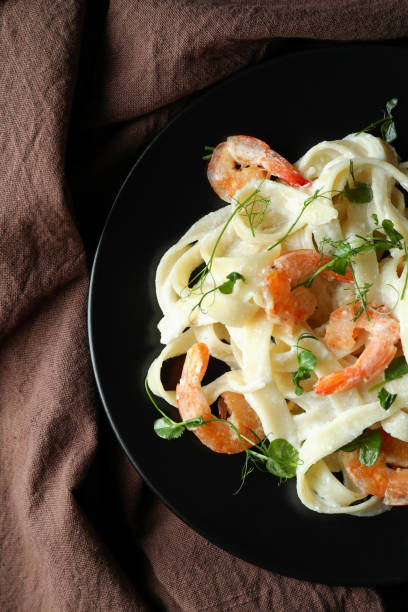 istock Plate of shrimp pasta on kitchen towel background 1440483098