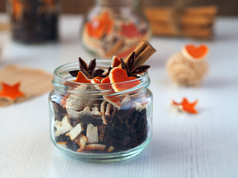 Dry aromatic potpourri with different spices in a jar. Homemade decorations for Christmas. Closeup, selective focus.