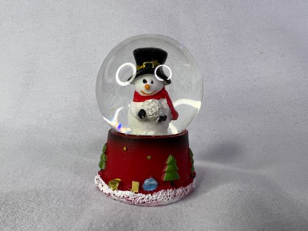 istock Glass globe with white snowman with pr hat. Christmas snow globe. White background. 1440484291