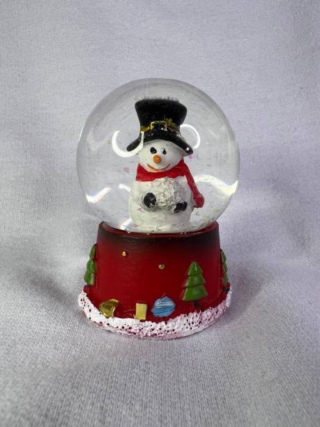 istock Glass globe with white snowman with pr hat. Christmas snow globe. White background. 1440484293