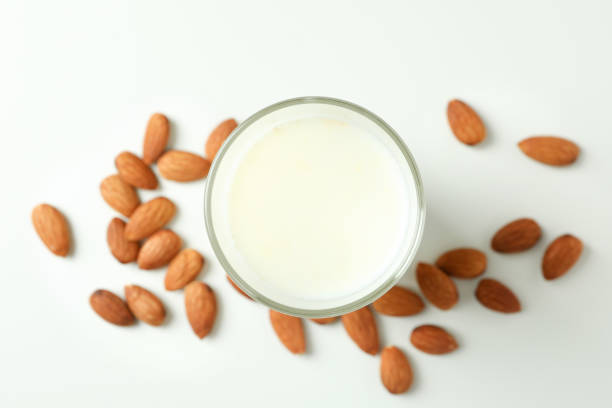 istock Glass of milk and almonds on white background 1440485358