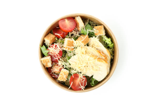 istock Paper bowl with Caesar salad isolated on white background 1440485625