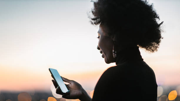 istock African woman looking at her phone 1440486308