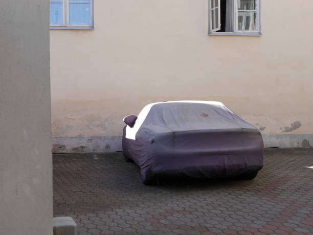 istock Covered car on street 1440486347
