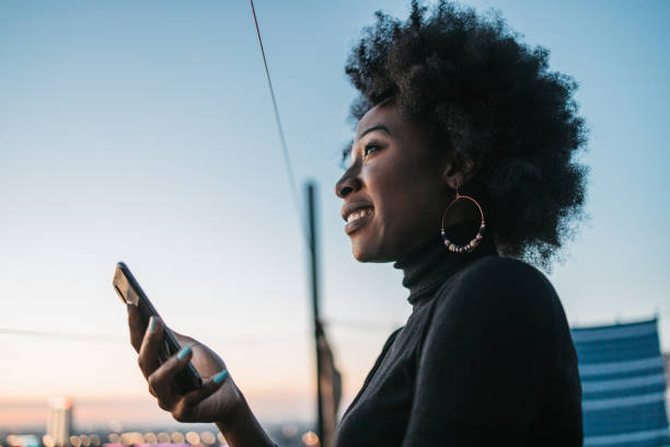 istock African woman looking at her phone 1440487828