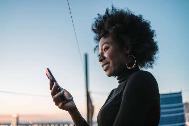 istock African woman looking at her phone 1440487876