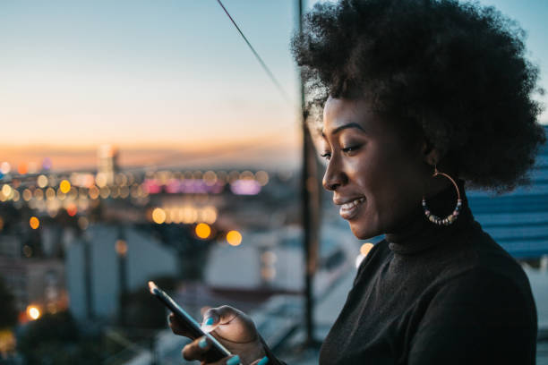 istock African woman looking at her phone 1440487900