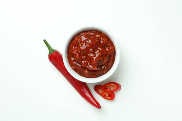 istock Red chili pepper and sauce on white background 1440488477