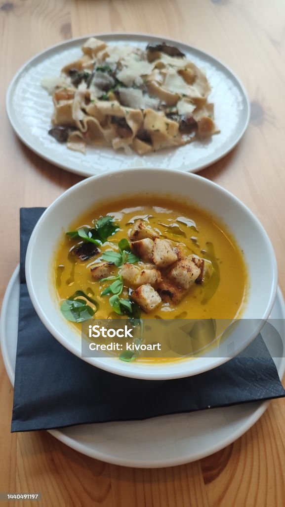 Cream soup Of Carrot and pasta pappardelle Lunch in restaurant Advice Stock Photo