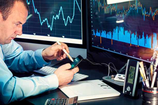 istock Businessman checking stock market data. He using a mobile phone. Analysis economy data on forex earn graph 1440491407