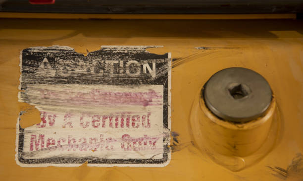 istock Worn safety sticker next to round bolt on bulldozer 1440492656