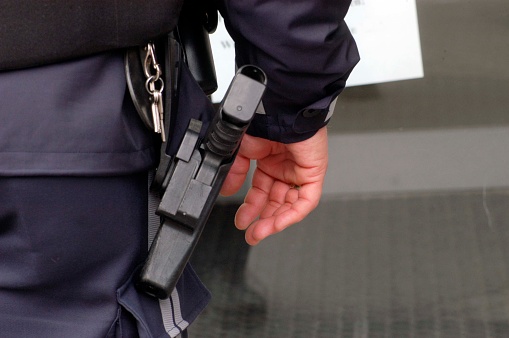 a police officer in police uniform with his service weapon