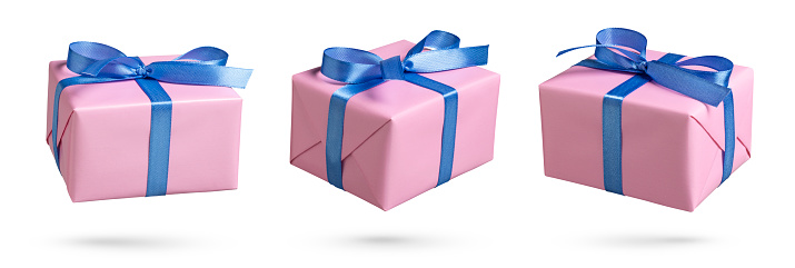 Set of pink gift boxes with blue ribbon on white. This file is cleaned and retouched.
