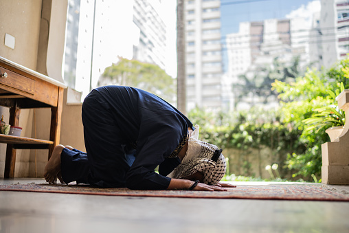 Young muslim man praying