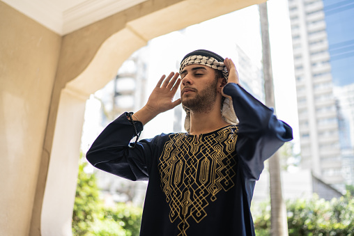 Young muslim man praying