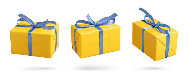 Yellow gift boxes with blue ribbon on white. This file is cleaned and retouched.