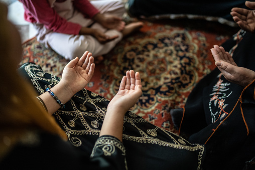 Muslim women praying at home
