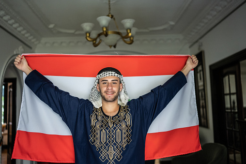 Portrait of a young man with Lebanese flag at home
