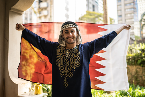 Portrait of a young man with Qatari flag