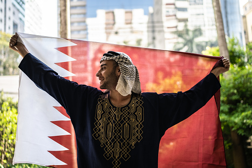 Portrait of a young man with Qatari flag