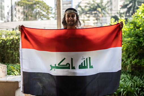 Portrait of a young man with Iraq flag