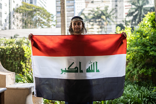 Portrait of a young man with Iraq flag