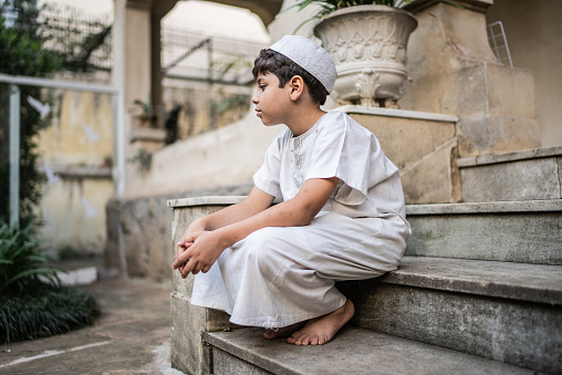 Boy sitting relaxing on the house steps