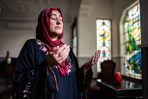 Mature islamic woman praying at home