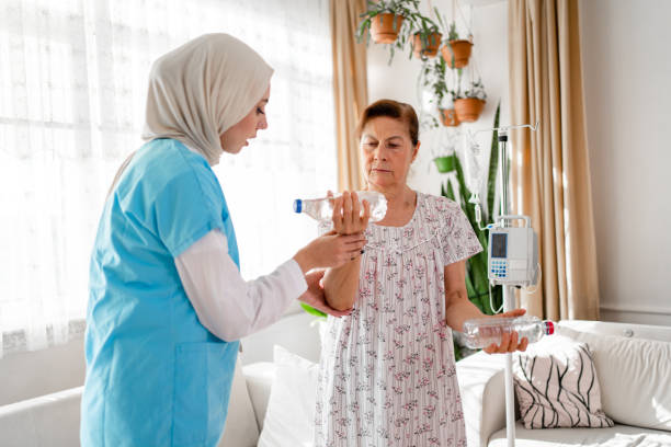 istock Older aged woman doing physiotherapist with support from muslim  nurse 1440496241