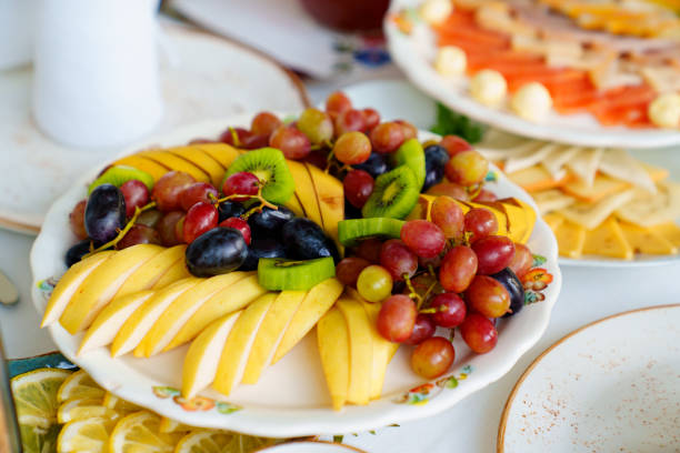 istock fruit platter. plate with chopped pear, apple, banana, kiwi and grape berries. 1440496576