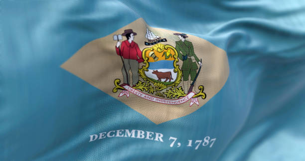 Close-up view of the Delaware state flag waving in the wind Close-up view of the Delaware state flag waving in the wind. Delaware is a state in the Mid-Atlantic region of the United States. Fabric textured background. Selective focus. 3D illustration delaware us state photos stock pictures, royalty-free photos & images