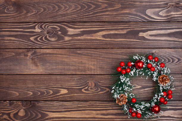 istock Christmas decorative wreath on wooden background 1440498819