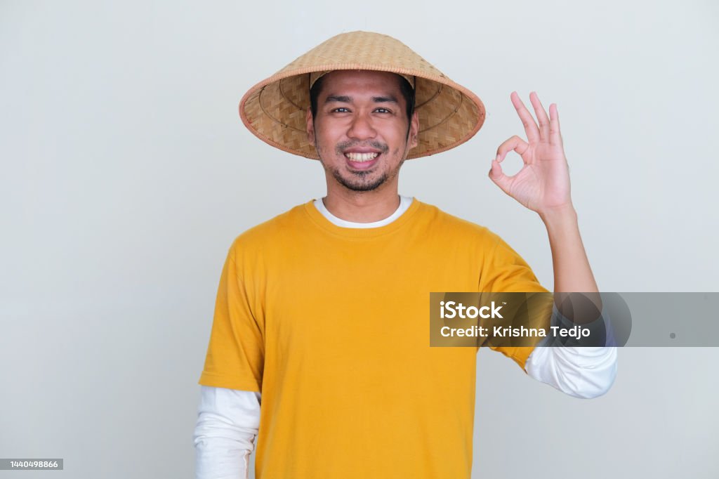 Young Indonesian farmer smiling at camera and give OK sign 35-39 Years Stock Photo