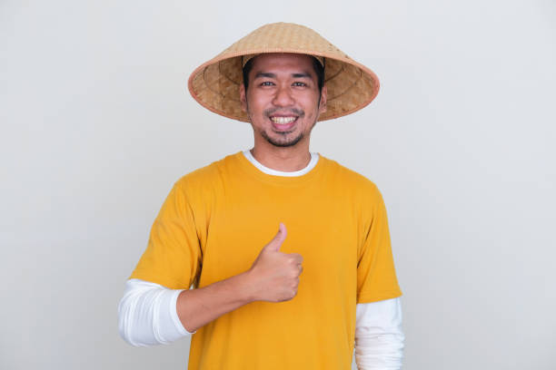 istock Young Indonesian farmer smiling at camera and give thumb up 1440498950