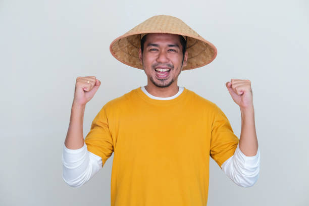 istock Young Indonesian farmer clench both his hand showing happiness 1440499007