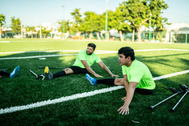 istock Amputee soccer players stretching on soccer field 1440501302