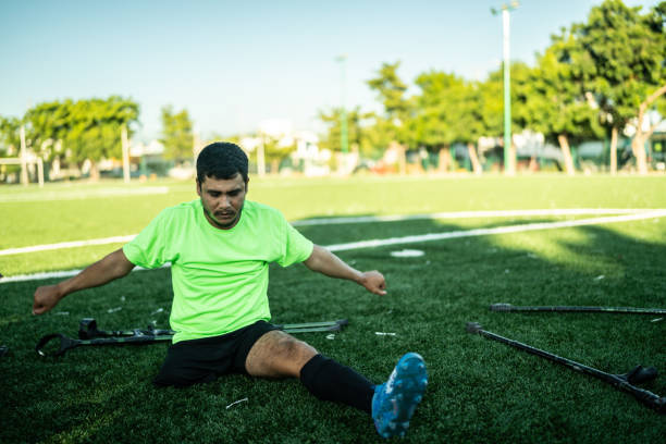 istock Young amputee soccer player stretching on soccer field 1440501358