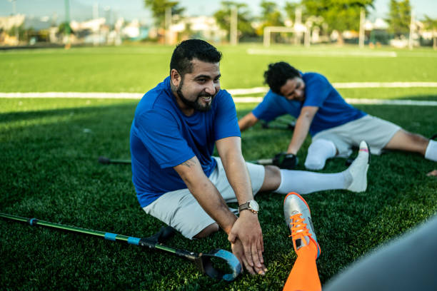 istock Amputee soccer players stretching on soccer field 1440501461