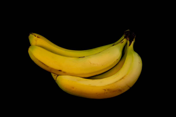 istock Yellow and ripe bananas isolated on black background 1440502878