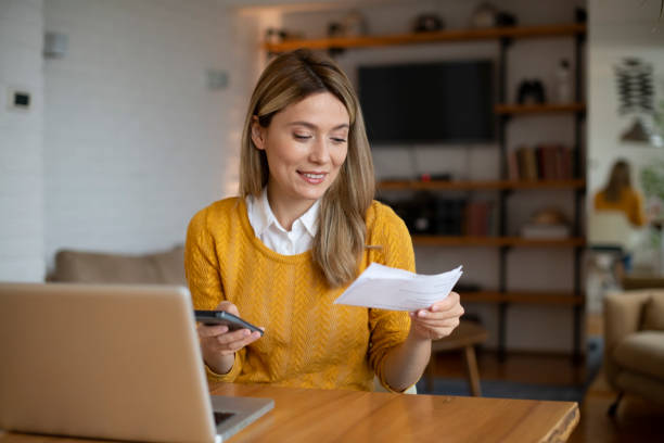 istock Woman planning home budget and using calculator stock photo 1440502995