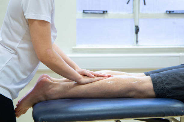istock Massage therapist providing a patient with a calf massage 1440503110