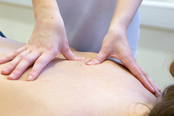 istock Close-up of massage therapist providing a patient with a back massage 1440503113