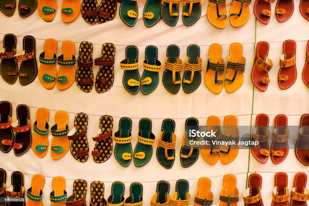 Colorful Handmade chappals (sandals) being sold in an Indian market, Handmade leather slippers, Traditional footwear. Ancient Stock Photo