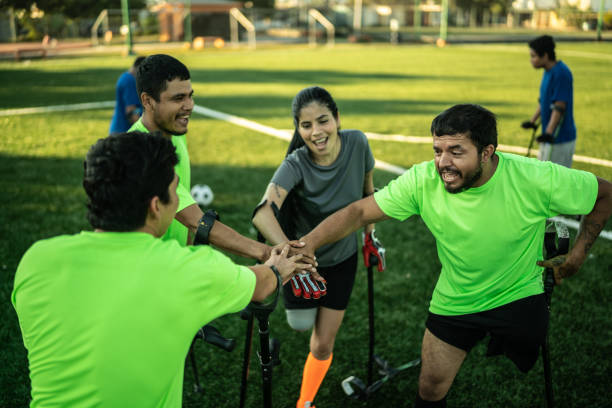 istock Amputees football team stacking hands before game 1440506338